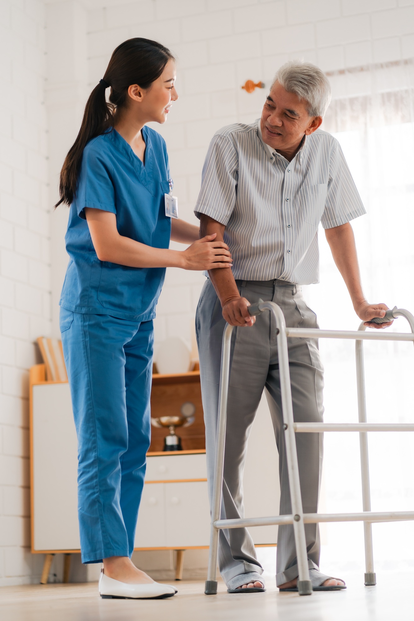Health insurance service, Young Asian caregiver nurse examine senior man or woman patient at home