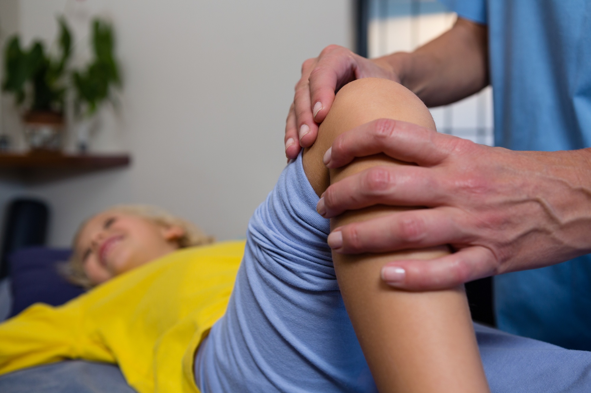 Physiotherapist giving physical therapy to the girl